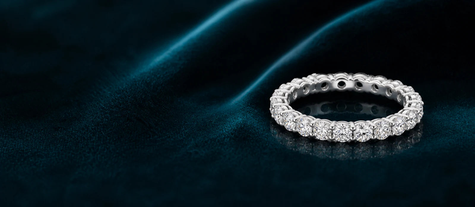 Statement eternity diamond ring on deep teal silk